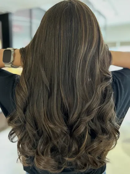 A cool and beautifully blended classic highlight technique. The three-tone color adds incredible depth, and the long layers haircut provides movement and style.
