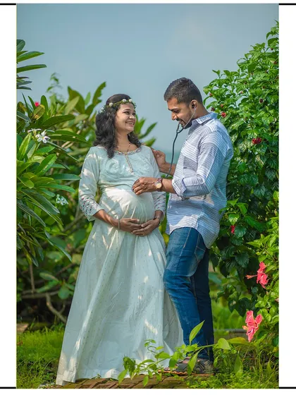 The dad-to-be playfully listens to the baby bump with a stethoscope, a cute and creative idea for your shoot.