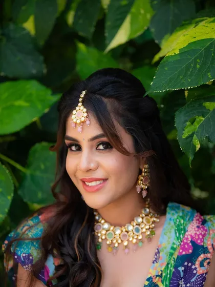 A close-up portrait of a model ready for her Mehendi ceremony. Her bright smile and colorful jewelry perfectly capture the festive and joyful mood.