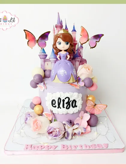 A fairytale cake for a little princess. This Sofia the First creation features a castle topper, beautiful butterflies, and floral details in a lovely lavender palette, perfect for a magical birthday.