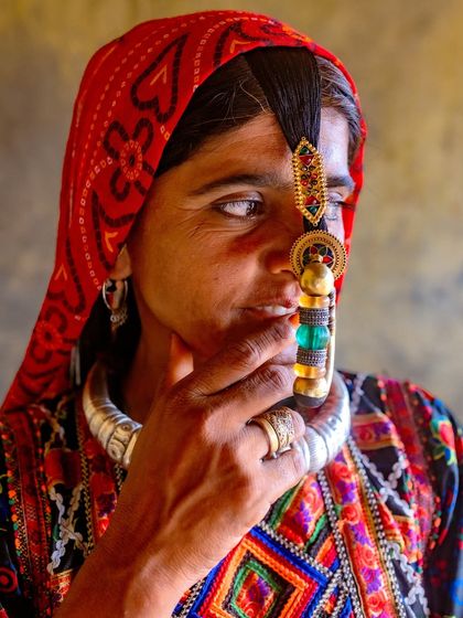 Another beautiful portrait of a Dhaneta Jat woman, highlighting the intricate details of her nose ring and the colorful embroidery on her clothing.