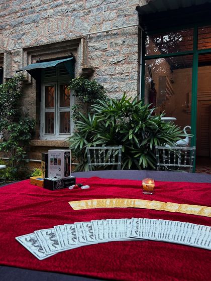 Another view of my reading table at the Arcesium event. The combination of the historic stone building, lush greenery, and the gentle glow of a candle created a truly special ambiance for the readings.