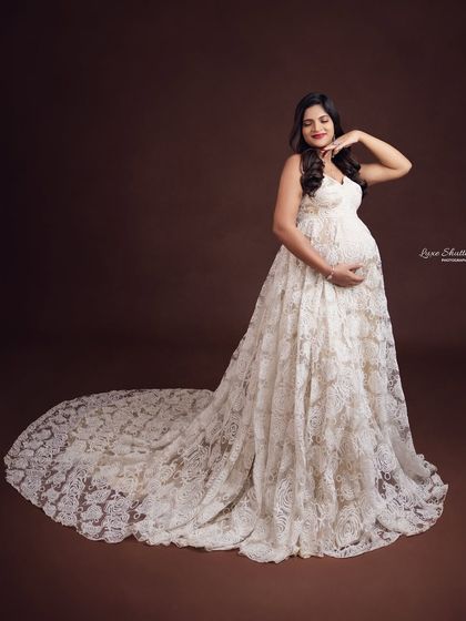 Carrying a tiny heartbeat and a whole lot of style. This mom-to-be is radiant in a beautiful white lace gown.