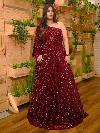 For a full glam look, this one-shoulder maroon sequin gown is a perfect choice. The all-over sparkle ensures you'll shine at any evening event.