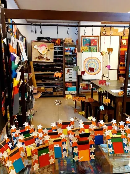 My studio is filled with layers of artwork and endless supplies. Every corner is designed to spark inspiration, from the shelves of paper and paint to the student creations that adorn the walls.
