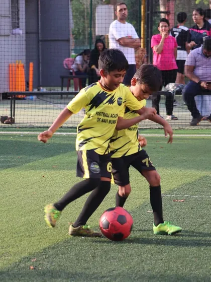 The heart of our academy is on the training ground. Here, two of our young players are locked in a friendly but focused duel for the ball, showcasing the passion and competitive spirit we nurture.