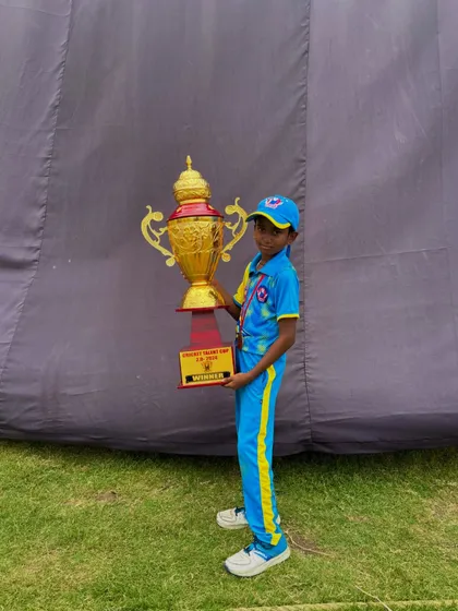 One of our youngest champions holding the big trophy.