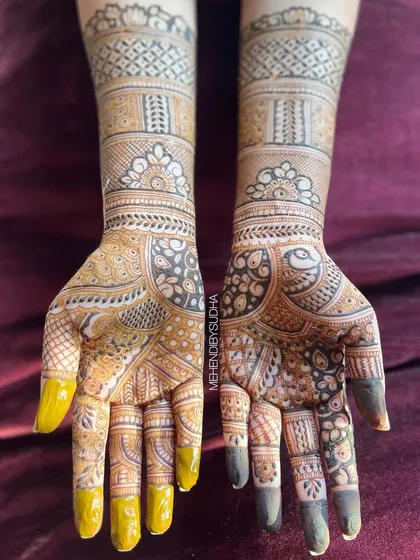 A top-down view that captures the full detail of the peacock and floral patterns on the palms and arms.