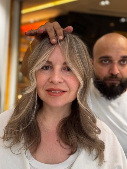 A shot with me and the client, both happy with the stunning pearl blond result.