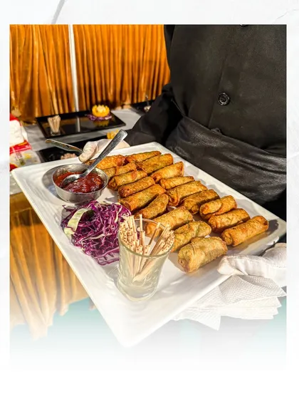 Our crispy spring rolls are a classic appetizer, perfectly fried and served with a sweet and spicy sauce. They are always a hit with guests of all ages.