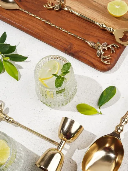 A complete flat-lay of the brass bar set, styled with drinks and garnishes, providing a comprehensive view of the collection.
