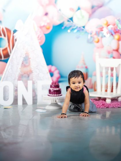 Tiny but mighty, and officially one! This little crawler is exploring his fun-filled birthday setup, ready to take on the world.