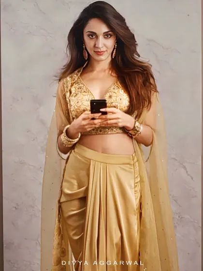 The stunning Kiara Advani in my golden Lydia Cape Set. This fusion wear piece combines a pre-draped dhoti skirt with an intricately embroidered blouse and a flowing organza cape, perfect for a modern wedding guest look.
