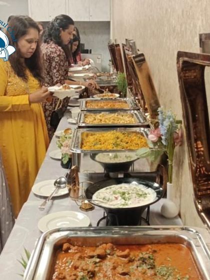 A side view of the bustling buffet line during the Diwali celebration at Blis Global. My team ensures the chafing dishes are always full and the area is kept clean throughout the event.