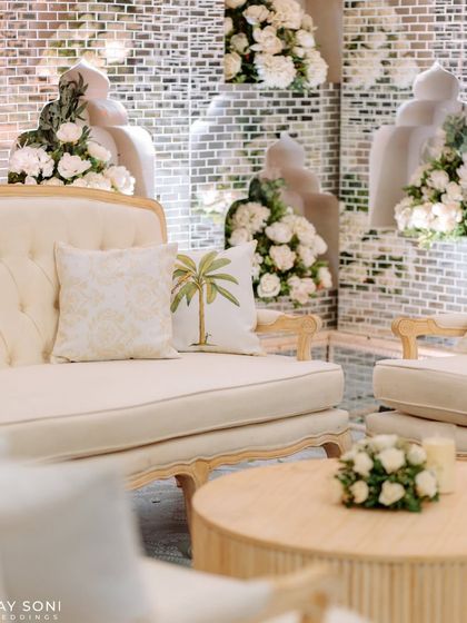 A close-up of the elegant lounge seating, showing the palm-tree embroidered cushion that adds a subtle tropical touch to the enchanted forest theme.