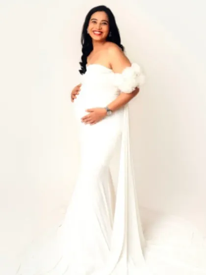 A smiling portrait in our white off-the-shoulder fitted gown, exuding pure happiness and elegance.