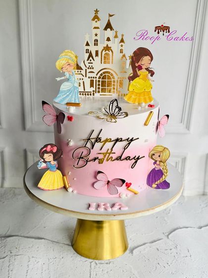 A royal celebration with all the Disney Princesses. This cake features Cinderella, Belle, Snow White, and Rapunzel around a beautiful castle topper, making any birthday a fairytale.
