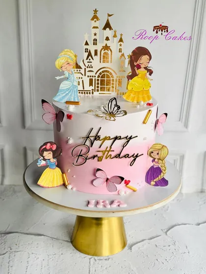 A fairytale come to life. This enchanting princess-themed birthday cake is perfect for little royalty, adorned with butterflies, a castle, and beloved Disney princesses.