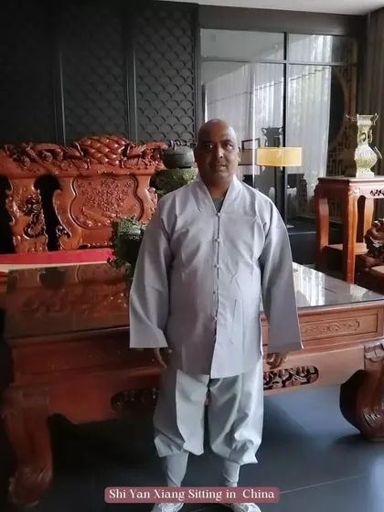A formal photo of me, Shi Yan Xiang, in traditional Shaolin attire in China. This represents my identity as a disciple of the temple.