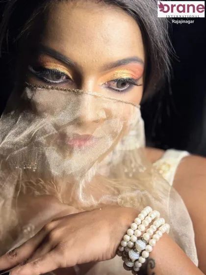 A mysterious and alluring shot with a sheer veil, highlighting the captivating eye makeup.