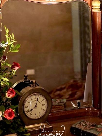 Another view of the "Love Book" station, with a vintage clock and elegant floral arrangement.