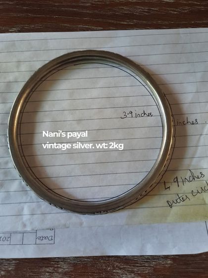 The process begins with understanding the story. This is a snapshot of a client's 'Nani's payal', a vintage silver anklet weighing 2kg, which we planned to incorporate into her wedding look, showcasing our attention to sentimental details.