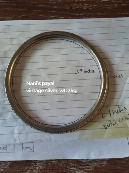 The process begins with understanding the story. This is a snapshot of a client's 'Nani's payal', a vintage silver anklet weighing 2kg, which we planned to incorporate into her wedding look, showcasing our attention to sentimental details.