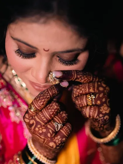 Another beautiful detail shot focusing on the eye makeup, lashes, and intricate henna design.