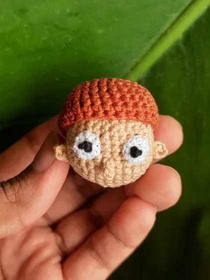 A close-up of the Morty Smith amigurumi. His wide-eyed, anxious look is what makes him Morty, and it was fun to capture in crochet form.