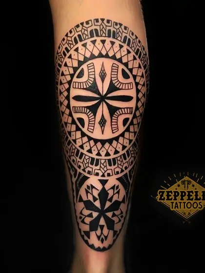 A bold Polynesian and geometric inspired leg tattoo. This style uses solid black patterns to create a powerful and visually striking piece.
