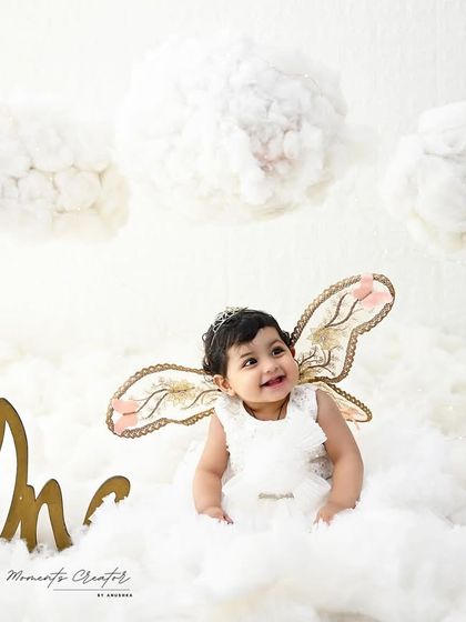 A smiling angel looking up at the clouds. The soft lighting and dreamy atmosphere of this setup create a truly magical and heartwarming portrait.