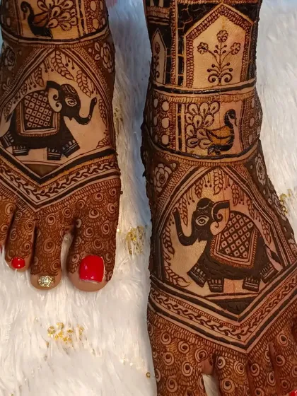 A close-up of the elephant motif on the feet, showing the detail and precision of the artwork.