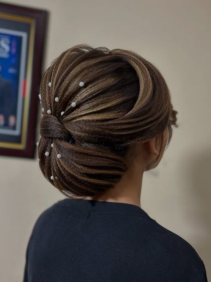 A beautiful and sophisticated updo with highlights woven through, creating dimension and texture.