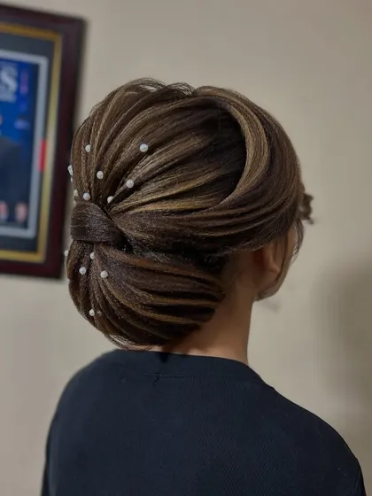 A beautiful and sophisticated updo with highlights woven through, creating dimension and texture.