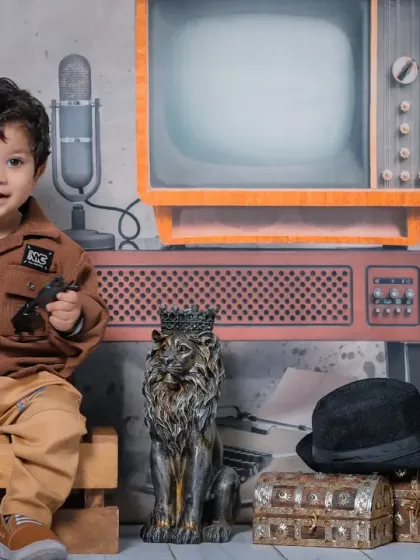 A close-up shot that brings you into the world of our little radio jockey. His expressive face and interaction with the props make for a memorable photo.