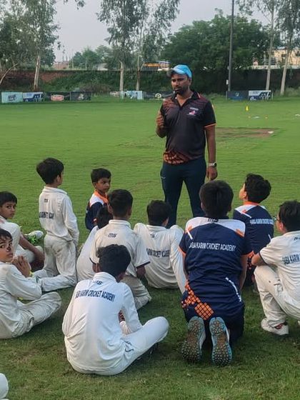 Another group of young players engaged in a discussion with their coach. We believe in building a strong team spirit and a sense of community.