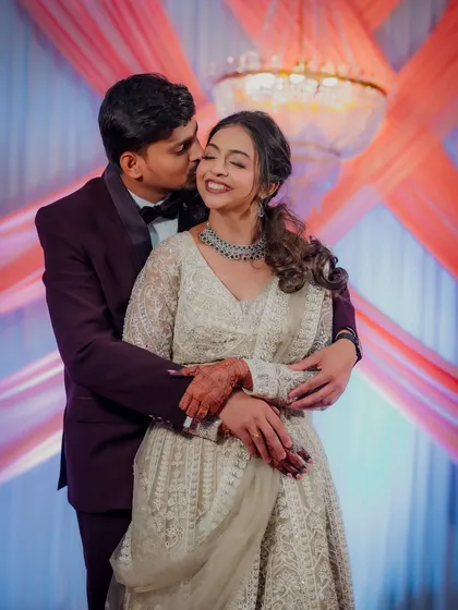 Engagement ceremonies are full of beautiful, fleeting emotions. I captured this sweet, candid kiss during the couple's celebration in Airoli, a perfect memory of their special day.
