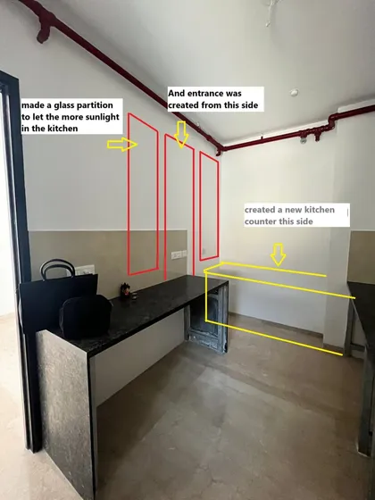 To improve the kitchen's flow and bring in more light, we created a new entrance with a glass partition and added a whole new counter. These civil changes are fundamental to creating a truly functional space.