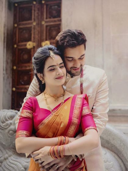 A tender embrace between Siri and Madhusudhan on their engagement day, showcasing their elegant traditional attire and the love between them.