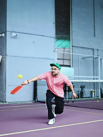 Action shot of a player making a dynamic move on the pickleball court. The indoor lighting and quality surface make it a great place for competitive play.
