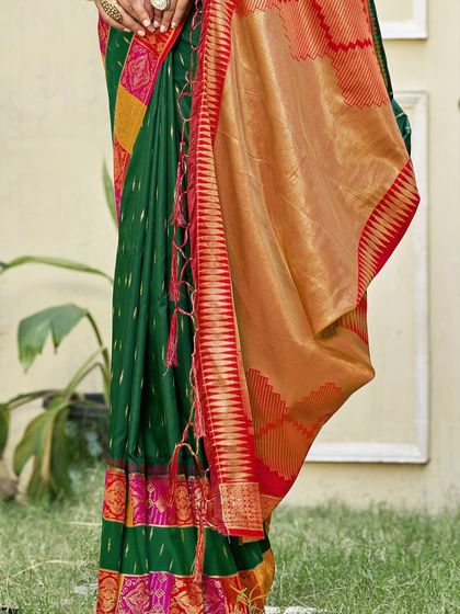 This bottle green Dupion silk saree is a classic beauty. The rich color and traditional border make it a perfect choice for any formal or festive occasion.