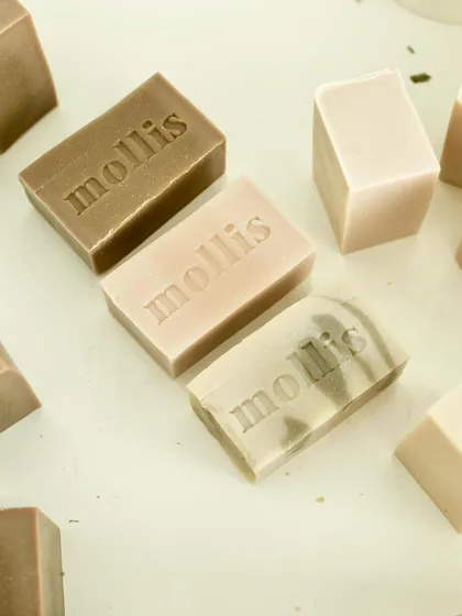A trio of earth-toned soaps, freshly stamped and ready for curing.