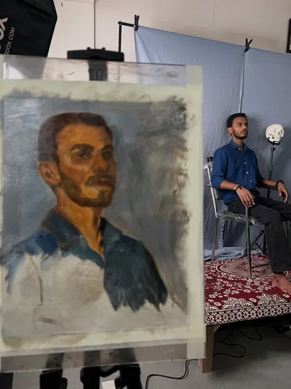 Here you can see the portrait of Satyam developing on the easel during the live session. This view shows the relationship between the painting and the model, capturing the dynamic process of painting from life.