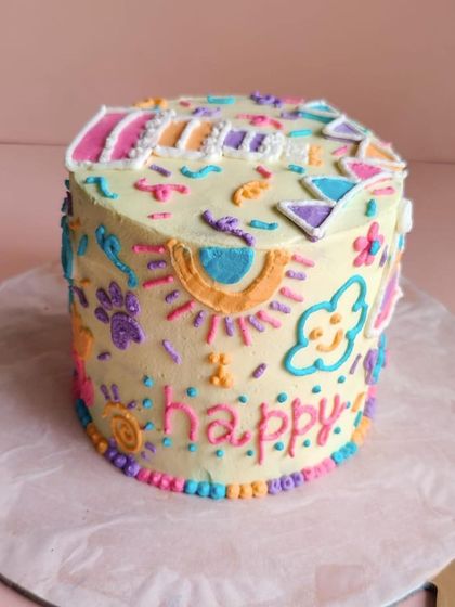 The "happy" side of Theo's cake, with a smiling cloud and sun. Our designs are meant to be as joyful as the occasion.