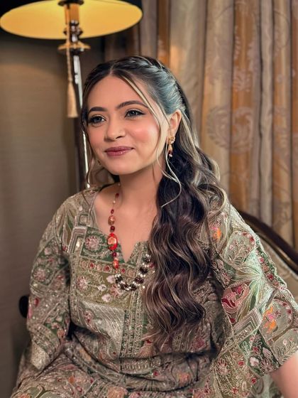 A smiling portrait of the Mehendi bride. Her makeup is natural and glowing, perfectly complementing her relaxed and happy vibe.