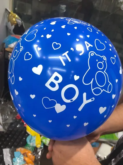 A close-up of our "It's a Boy" printed latex balloon. This cute design features teddy bears and hearts, perfect for adding a thematic touch to any baby shower or welcome home bouquet.