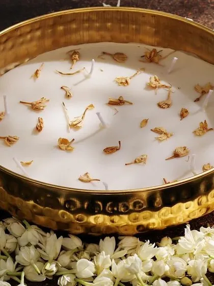 The elegant Urli candle in Jasmine fragrance, surrounded by fresh flowers, perfect for a stylish Diwali celebration.