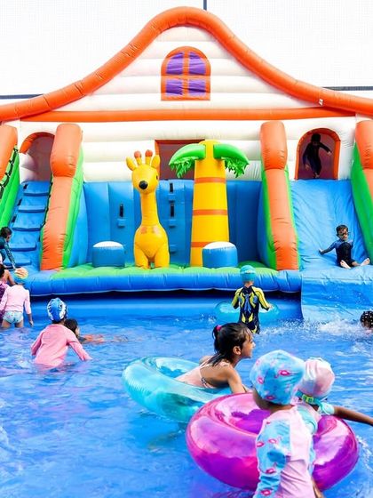 A full view of the giant inflatable water slide, a main attraction at many of my pool parties that guarantees hours of fun.
