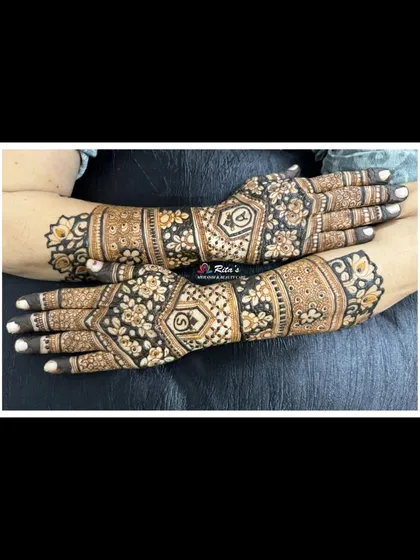 An elegant back-of-hand design for the Teej festival. The pattern is intricate but doesn't provide full coverage, giving it a modern feel.