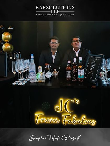 Our bartenders at a sleek, modern bar setup for a private birthday celebration, complete with custom neon signage.